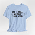 Christian Inspirational Tee - "God Is Still Writing Your Story" Graphic Shirt
